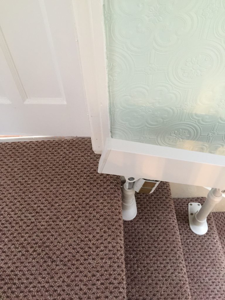 Brooks-180-T565-Curved-Stairlift Rail at top of stairs