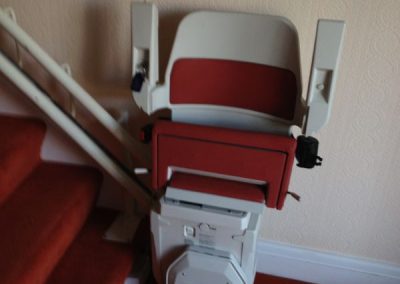 Halton Sapphire Curved Stairlift with Red Upholstery