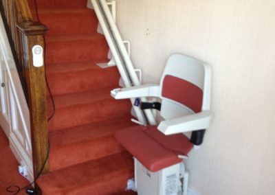 Halton Sapphire Curved Stairlift with red upholstery