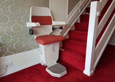 Halton-Sapphire-Curved-Stairlift-Curve-Chairlift in Red Upholstery