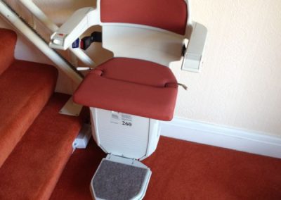 Halton Sapphire Curved Stairlift with Red Upholstery