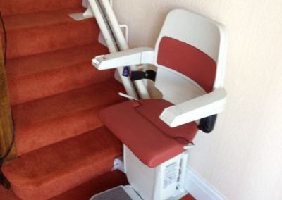 Halton Sapphire Curved Stairlift with red upholstery