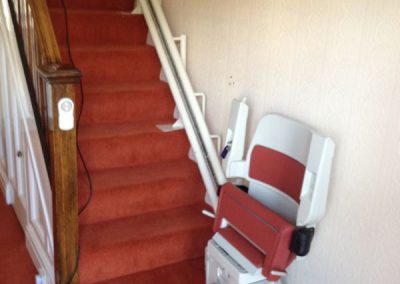 Halton Sapphire Curved Stairlift with Red Upholstery
