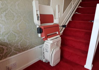 Halton-Sapphire-Curved-Stairlift-Curve-Chairlift in Red Upholstery