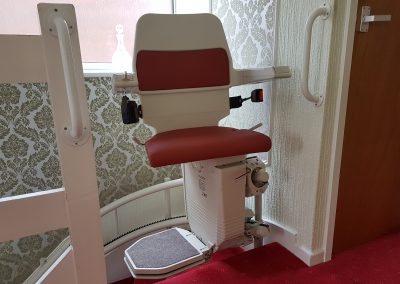 Stannah Sarum Curved Stairlift with Red Upholstery