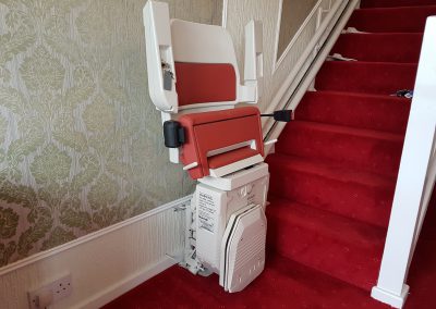 Stannah Sarum Curved Stairlift with Red Upholstery Folded